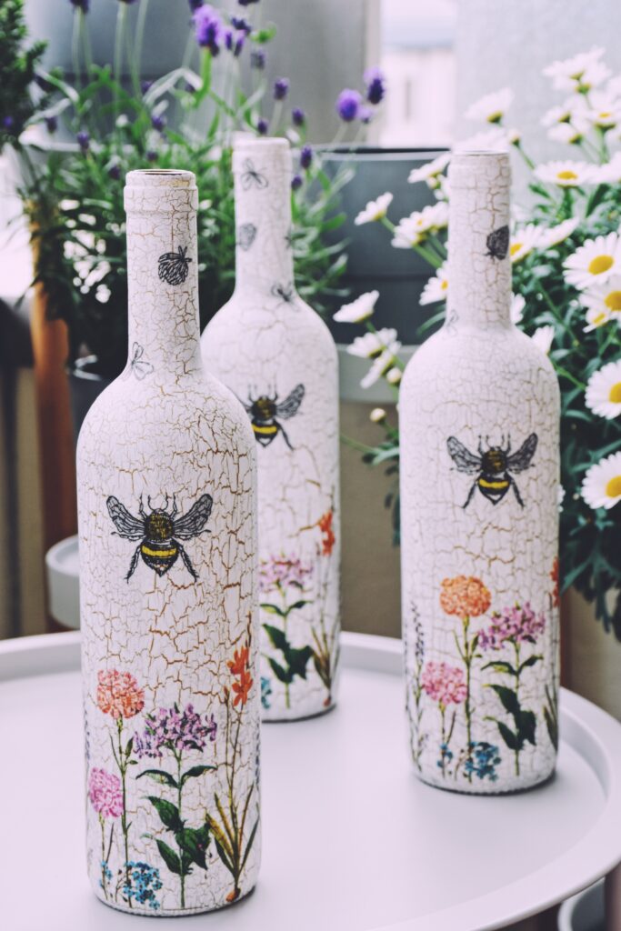 Upcycled glass bottles as watering cans in the urban garden
