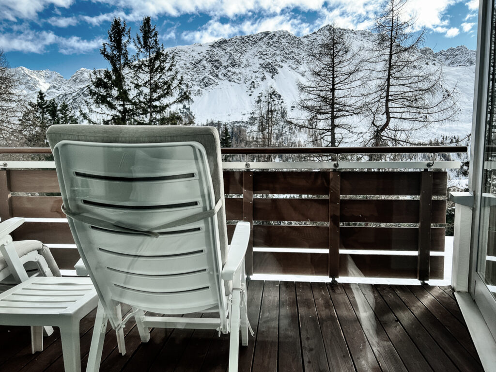 Tschuggen Grand Hotel View of Snowy Swiss Alps and the Room's Balcony with the chair